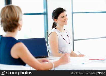 Business woman talking to her collegues in office