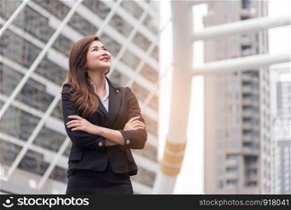 Business woman thinking and look up for succeed in project. Happy life and Business successful concept. Urban and outdoor
