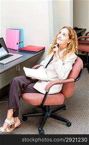 Business woman thinking at office desk