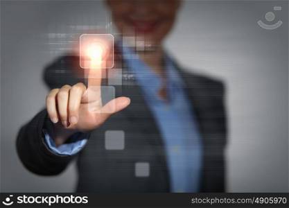 Business woman touching display. Business woman touching virtual display. Business and technology concept
