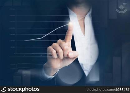 Business woman touching graph. Business woman touching graph at futuristic screen