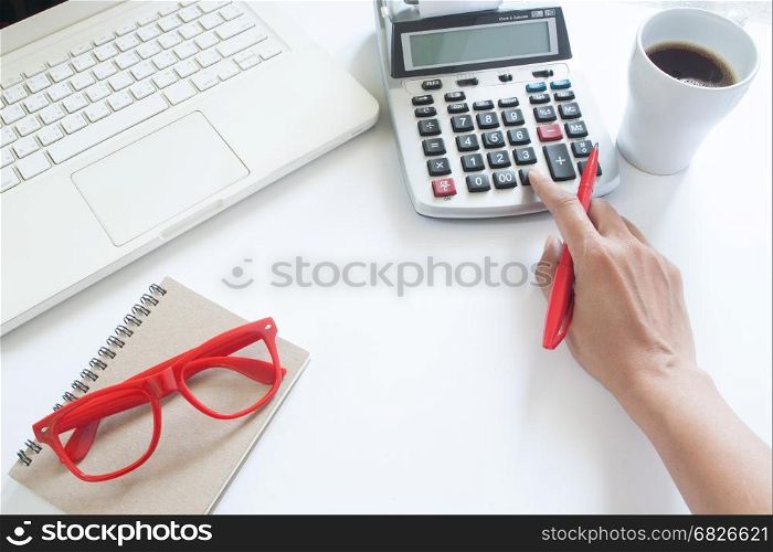 Business woman using calculator and laptop computer on white office desk, Accounting concept with copy space