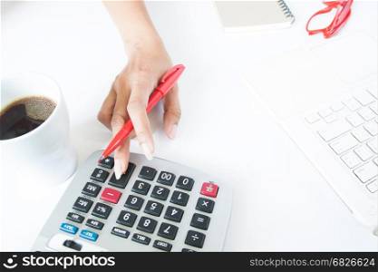 Business woman using calculator and laptop on white desk, Accounting and tax concept