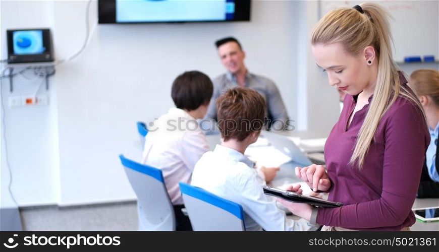 Business Woman Using Digital Tablet in Busy Office