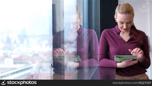 Business Woman Using Digital Tablet in corporate office by window