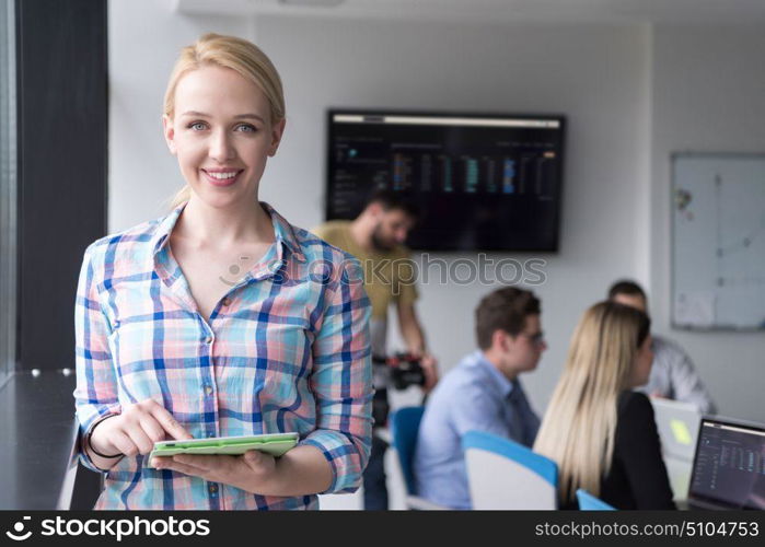 Business Woman Using Digital Tablet in corporate office by window