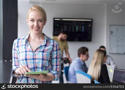 Business Woman Using Digital Tablet in corporate office by window