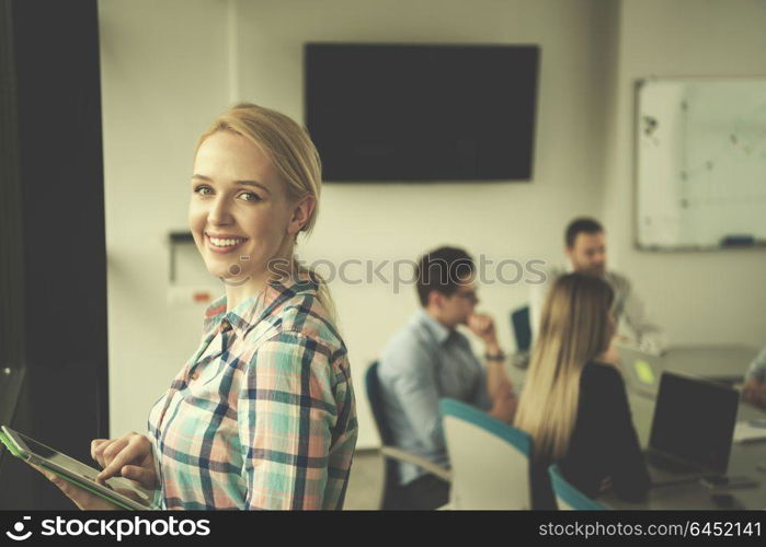 Business Woman Using Digital Tablet in corporate office by window