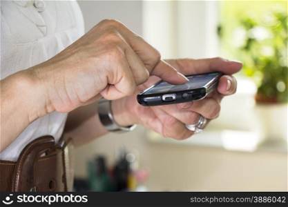 Business Woman using her cell phone in office