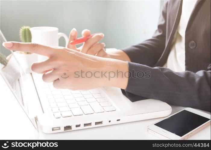 Business woman using laptop. Business woman in black suit