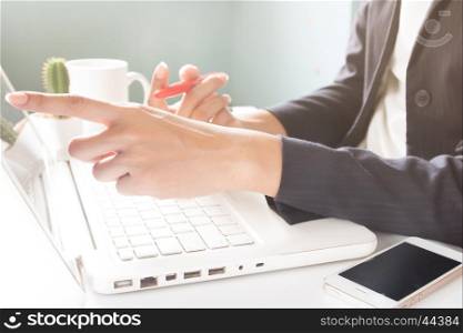 Business woman using laptop. Business woman in black suit