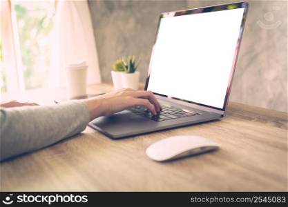 Business woman using laptop computer do online activity on wood table at home office.