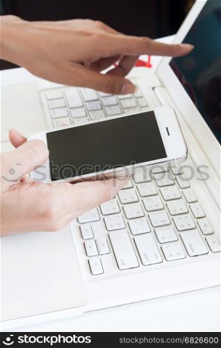 Business woman using mobile device and laptop, Business and technology concept
