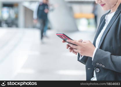 Business woman using smartphone shopping online, call, texting message internet technology lifestyle. Asian woman using cellphone walking on city street. Smart phone smart confident woman modern city