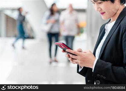 Business woman using smartphone shopping online, call, texting message internet technology lifestyle. Asian woman using cellphone walking on city street. Smart phone smart confident woman modern city