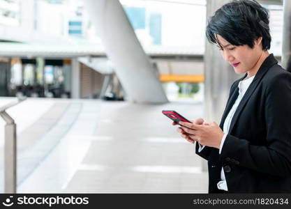 Business woman using smartphone shopping online, call, texting message internet technology lifestyle. Asian woman using cellphone walking on city street. Smart phone smart confident woman modern city