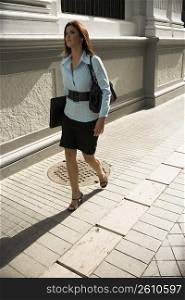 Business woman walking, outdoors