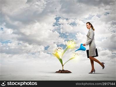Business woman watering monet tree