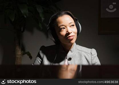 Business woman wearing headphones