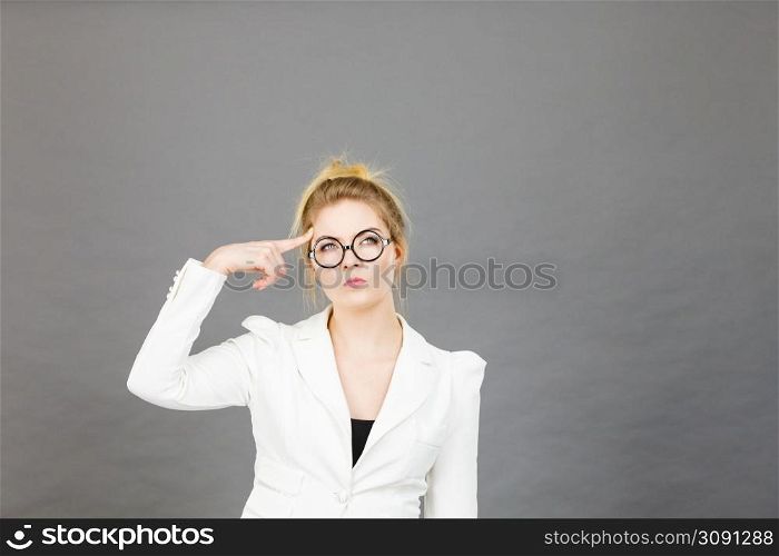 Business woman wearing white jacket and eyeglasses intensive thinking finding great problem solution.. Business woman intensive thinking