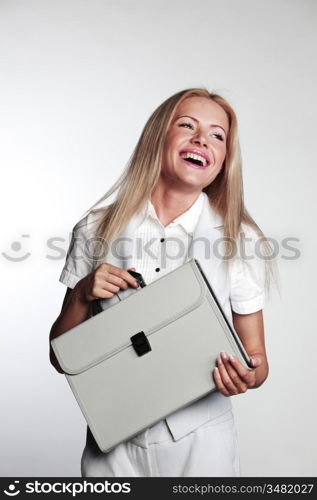 business woman with a briefcase on a gray background