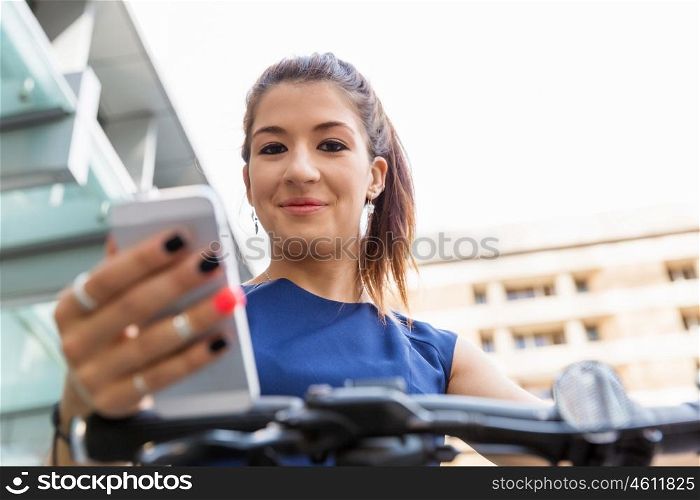 Business woman with a smart phone. Business woman in a street using her smart phone