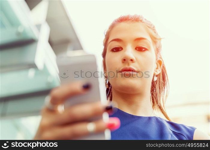 Business woman with a smart phone. Business woman in a street using her smart phone