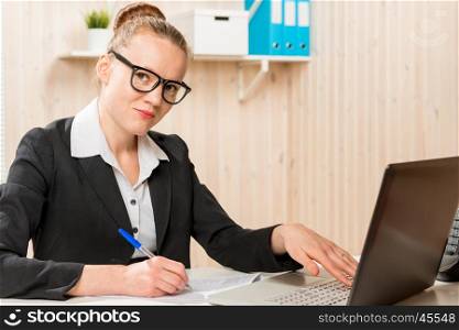 Business woman with black glasses working at a computer