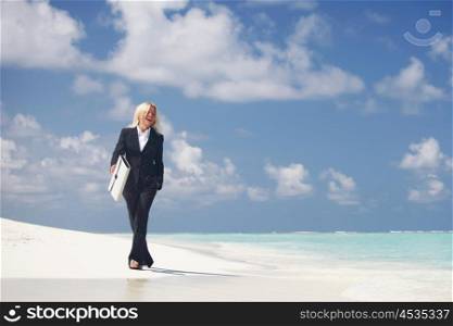 Business woman with briefcase walking on ocean beach. Business woman on beach