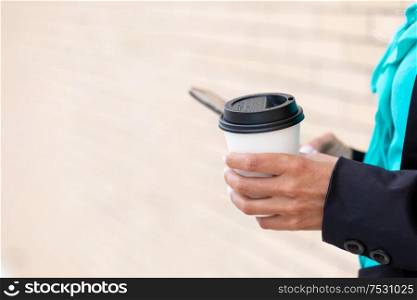 Business woman with coffe and talking on the phone near office