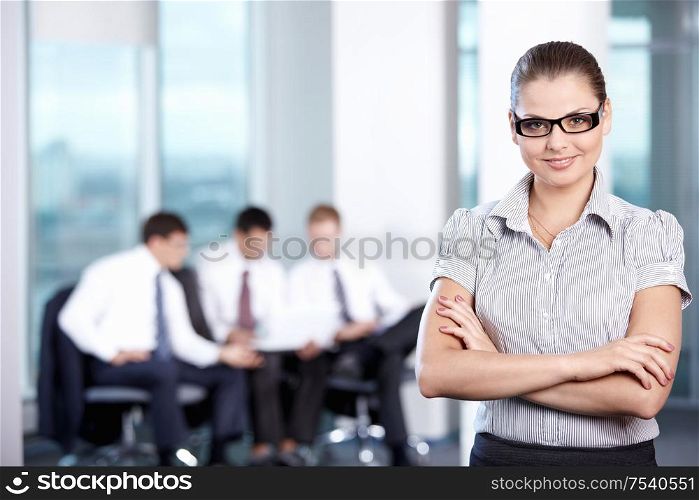 Business woman with glasses in the foreground