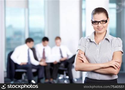 Business woman with glasses in the foreground