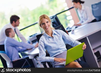 business woman with her staff, people group in background at modern bright office indoors