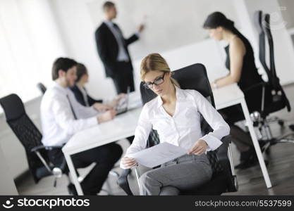 business woman with her staff, people group in background at modern bright office indoors