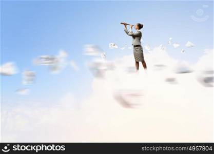 Business woman with telescope. Image of businesswoman looking in telescope standing atop of cloud