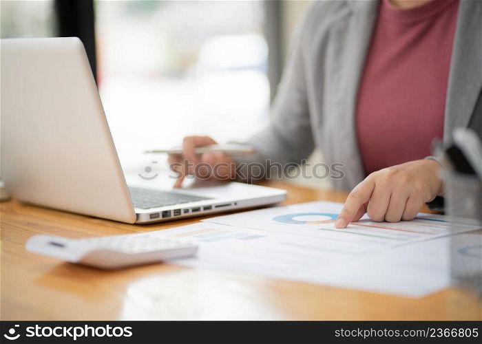 Business Woman working by using laptop computer Hands typing on a keyboard. Professional investor working new start up project. business planning in office. Technology business Concept.