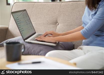 Business woman working from home. work online on laptop. Asian businesswoman working on sofa online business with social distancing laptop online meeting.