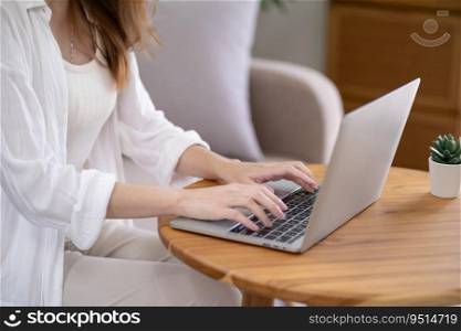 Business woman working from home. work online on laptop. Asian businesswoman working on sofa online business with social distancing laptop online meeting