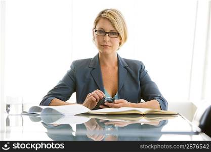 Business woman working in conference room, portrait