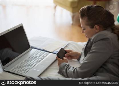 Business woman working on bed in hotel room