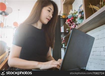 business woman working on laptop and looking at screen in home office as agile technology concept