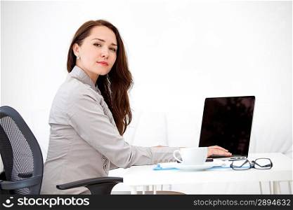 Business woman working on laptop computer at office