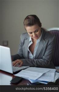 Business woman working with documents and laptop