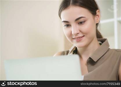 Business woman works on laptop computer in cozy home office while having concentration and thinking about her business. Small business and home office concept.