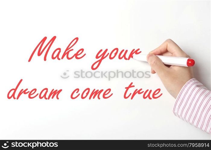 Business woman writing make your dream come true word on whiteboard