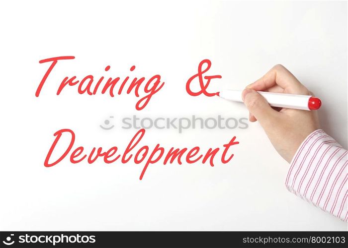 Business woman writing training and development word on whiteboard