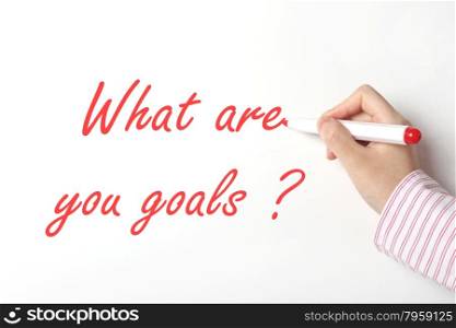 Business woman writing what are you goals word on whiteboard