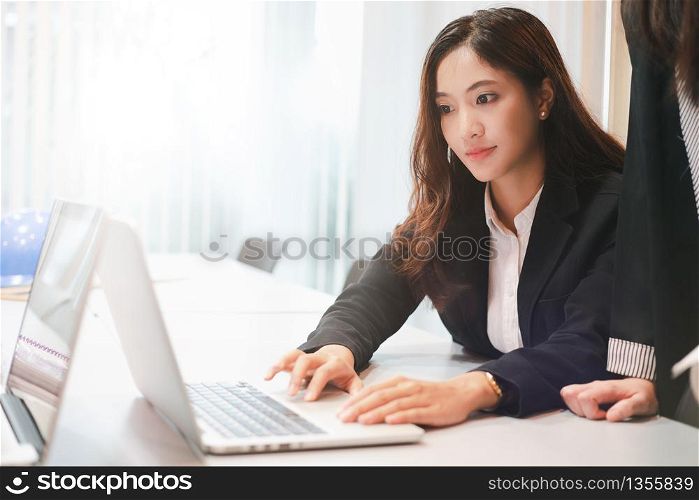 business women and Engineer group using notebook for business partners discussing documents and ideas at meeting and business women smiling happy for working