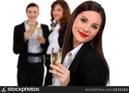 Business women drinking champagne
