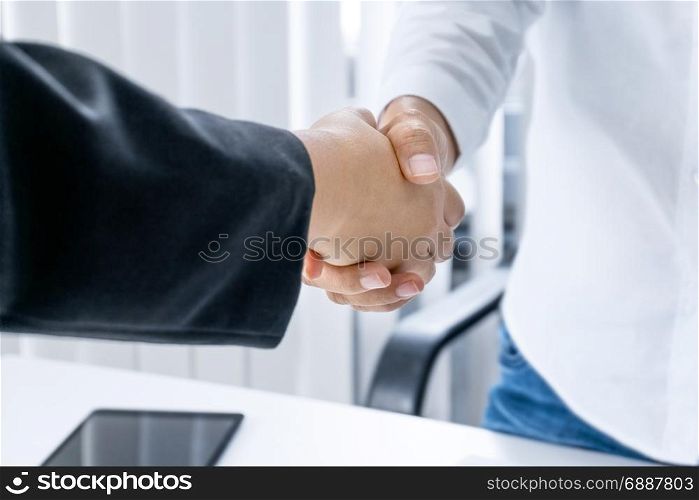 business women hands shaking at meeting room